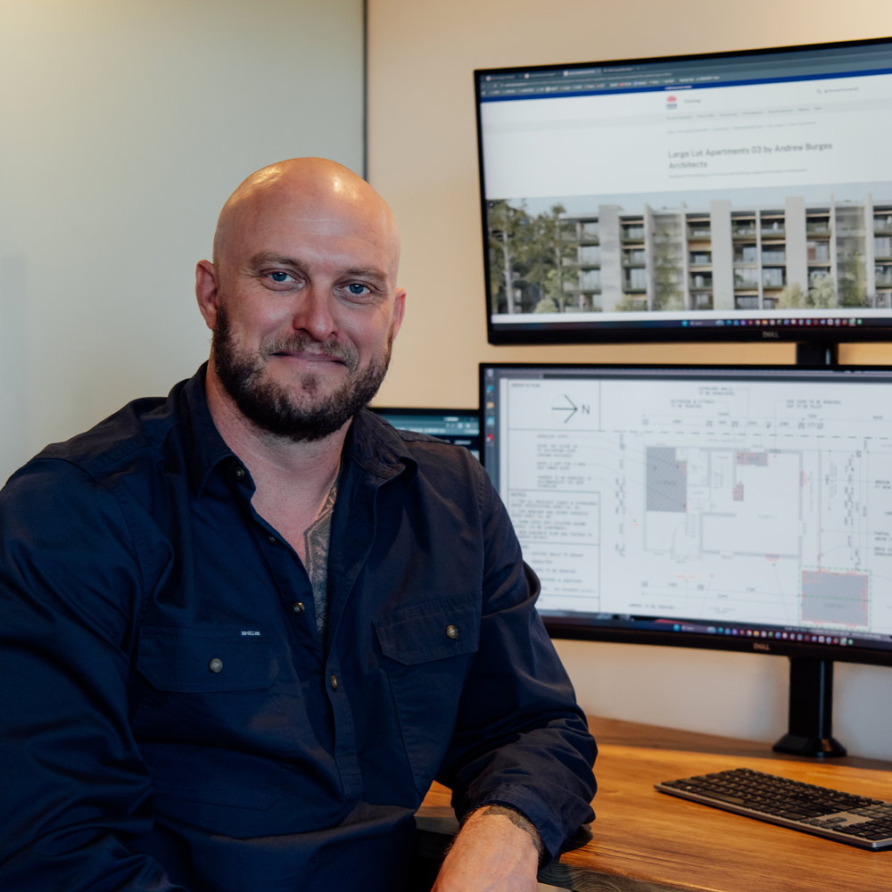 Toby McCosker working as Operations Manager, project drawings on screen